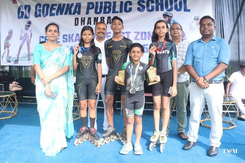 Young skaters holding medals and trophies with school staff and officials at the CBSE Zonal Skating Championship at G D Goenka Public School, Dhanbad