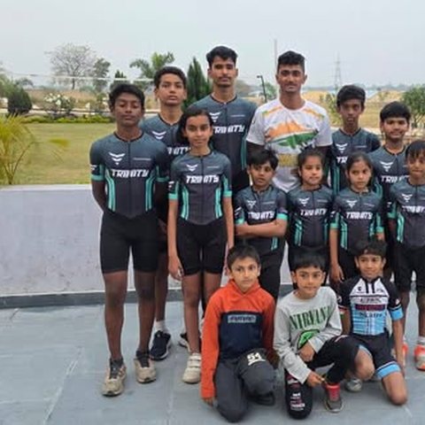 Young skaters in team kit lined up with their coach at the Dhanush Babu training camp in Dhanbad