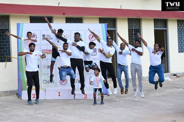 Group jump photo in front of the sponsor backdrop