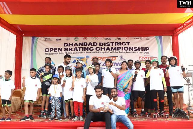 Medal winners standing together on stage under the championship banner