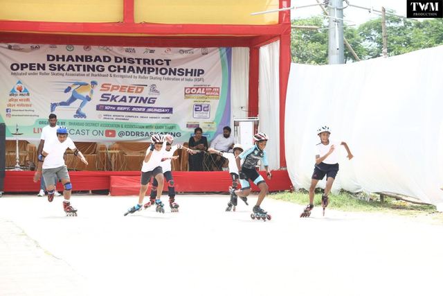 Skaters setting off at the start of a race in front of the championship banner