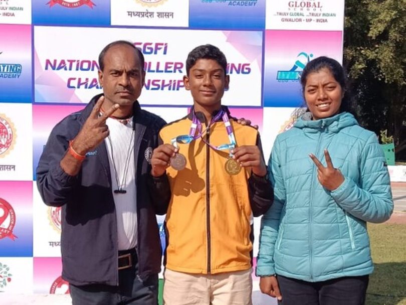 Young skater with a gold and a bronze medal in front of the national roller skating championship backdrop in Gwalior