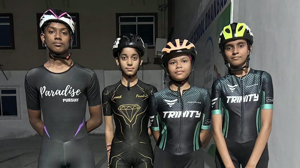 Four Dhanbad skaters selected in the SGFI state selection trials, standing together in racing suits and helmets